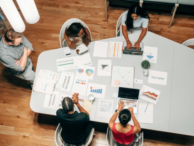 Office workspace with people collaborating